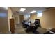 A conference room features a large table surrounded by office chairs under fluorescent lighting panels at 22 W 8Th St, Anderson, IN 46016