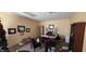 A cluttered office features a large desk, multiple chairs, and various framed documents on the walls at 22 W 8Th St, Anderson, IN 46016