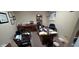 A cluttered office space with wooden desk, multiple chairs, and papers scattered on surfaces at 22 W 8Th St, Anderson, IN 46016