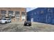 Parking lot with a black BMW Z4 and a white Chevy HHR, set against a blue and brick building backdrop at 22 W 8Th St, Anderson, IN 46016