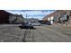 Asphalt parking lot with several vehicles including a convertible and an older brick building at 22 W 8Th St, Anderson, IN 46016