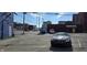 Commercial parking lot featuring various parked cars, and businesses in the background at 22 W 8Th St, Anderson, IN 46016