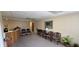A waiting area with chairs, plants, and carpeted floors at 22 W 8Th St, Anderson, IN 46016