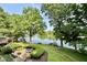 Expansive backyard featuring lush landscaping, a lakeside patio, and private dock, offering endless outdoor enjoyment at 2213 E Canterbury Ct, Martinsville, IN 46151