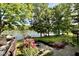 Backyard landscaping leading to lakefront with boat dock at 2213 E Canterbury Ct, Martinsville, IN 46151