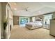 Inviting bedroom with tray ceilings, fireplace, and sliding door to a deck, offering comfort and style at 2213 E Canterbury Ct, Martinsville, IN 46151
