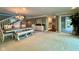 Bright dining area with a modern chandelier, stairs, and access to the deck at 2213 E Canterbury Ct, Martinsville, IN 46151