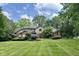 Beautifully landscaped yard and traditional brick home with a manicured lawn at 2213 E Canterbury Ct, Martinsville, IN 46151