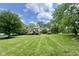 Charming home with a well-manicured front lawn, mature trees, and inviting curb appeal at 2213 E Canterbury Ct, Martinsville, IN 46151