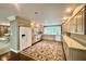 Open kitchen with wood floors, white cabinets, and bright natural light at 2213 E Canterbury Ct, Martinsville, IN 46151