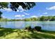 Scenic view of the lake framed by lush trees and greenery, showcasing natural beauty and tranquility at 2213 E Canterbury Ct, Martinsville, IN 46151