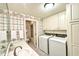 Convenient laundry room/bathroom with plenty of cabinet space and modern washer/dryer at 2213 E Canterbury Ct, Martinsville, IN 46151