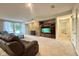 Cozy living room with stone fireplace, plush seating, and a walkout to the backyard at 2213 E Canterbury Ct, Martinsville, IN 46151