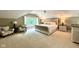 Main bedroom featuring a plush bed, accent chairs, and a large window with a view at 2213 E Canterbury Ct, Martinsville, IN 46151