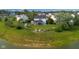 Aerial view of the property with a large backyard, fire pit, and landscaping at 2247 Rolling Hill Ct, Columbus, IN 47201