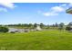 Expansive backyard with lush green lawn, fire pit, and scenic pond view at 2247 Rolling Hill Ct, Columbus, IN 47201