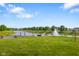 Backyard view of a lake with a fountain, a fire pit, and chairs at 2247 Rolling Hill Ct, Columbus, IN 47201