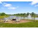 Backyard featuring a fire pit with Adirondack chairs overlooking the lake and fountain at 2247 Rolling Hill Ct, Columbus, IN 47201
