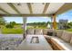 Backyard patio seating area with lake view, outdoor fire pit table, and play set at 2247 Rolling Hill Ct, Columbus, IN 47201