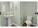Bathroom with pedestal sink, modern toilet, and neutral paint at 2247 Rolling Hill Ct, Columbus, IN 47201