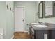 Bathroom with dual sinks, granite countertop, mirrors, and modern fixtures at 2247 Rolling Hill Ct, Columbus, IN 47201