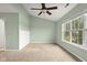 Bedroom with carpet, a ceiling fan, neutral walls, and large windows at 2247 Rolling Hill Ct, Columbus, IN 47201