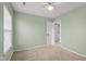 Comfortable bedroom with neutral carpet, mint-green walls, and a ceiling fan for added comfort at 2247 Rolling Hill Ct, Columbus, IN 47201