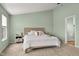 Cozy bedroom boasts soft carpet, a comfortable bed, and calming green walls at 2247 Rolling Hill Ct, Columbus, IN 47201