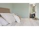 Tastefully decorated bed in a room with calming green walls and an open doorway to the bathroom at 2247 Rolling Hill Ct, Columbus, IN 47201