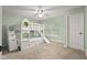 Spacious bedroom with bunkbeds, ceiling fan, carpet flooring, and door at 2247 Rolling Hill Ct, Columbus, IN 47201