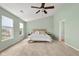 Spacious bedroom with vaulted ceiling, ceiling fan, carpeted floor, and comfortable bed at 2247 Rolling Hill Ct, Columbus, IN 47201