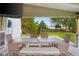 View of the outdoor dining area under the covered patio with TV and outdoor lighting at 2247 Rolling Hill Ct, Columbus, IN 47201