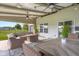 Relaxing covered patio with comfortable seating, fire pit, and ceiling fans at 2247 Rolling Hill Ct, Columbus, IN 47201