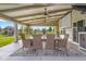 Covered patio with outdoor dining area, ceiling fans, and backyard view at 2247 Rolling Hill Ct, Columbus, IN 47201