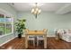 Sun-filled dining room with light wood table, chairs and view to the backyard at 2247 Rolling Hill Ct, Columbus, IN 47201