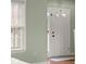 Bright entryway featuring natural light through the front door with adjacent window and light green walls at 2247 Rolling Hill Ct, Columbus, IN 47201