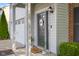 Charming front door with a 'Welcome' sign, sidelight window, and cozy, covered porch at 2247 Rolling Hill Ct, Columbus, IN 47201