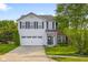 Charming two-story home featuring a well-maintained lawn and an attached two-car garage at 2247 Rolling Hill Ct, Columbus, IN 47201