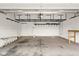 Clean garage with overhead storage racks and a work bench at 2247 Rolling Hill Ct, Columbus, IN 47201