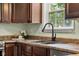 Updated kitchen area featuring stainless steel sink and dark wooden cabinets at 2247 Rolling Hill Ct, Columbus, IN 47201