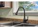 Close-up of kitchen sink featuring a modern faucet and view from the window at 2247 Rolling Hill Ct, Columbus, IN 47201