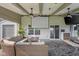 Covered patio with outdoor seating, movie screen, tv, fan, and fire pit at 2247 Rolling Hill Ct, Columbus, IN 47201