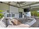Entertainer's patio with outdoor seating, TV, movie screen, fan, and fire pit at 2247 Rolling Hill Ct, Columbus, IN 47201