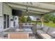 Inviting covered patio area with cozy seating around a fire pit and outdoor dining at 2247 Rolling Hill Ct, Columbus, IN 47201