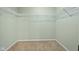 Empty walk-in closet features carpet flooring and wire shelves at 2247 Rolling Hill Ct, Columbus, IN 47201