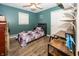 Bright bedroom featuring hardwood floors, a full-sized bed, and a large closet for storage at 2457 N Centerline Rd, Franklin, IN 46131
