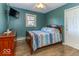 Bedroom with wood-look floors, mounted TV, and a large window with natural light at 2457 N Centerline Rd, Franklin, IN 46131