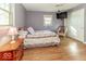 Bedroom with hardwood floors, mounted TV, and natural lighting at 2457 N Centerline Rd, Franklin, IN 46131