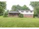 Charming split-level home featuring a brick facade, light siding, mature trees, and a well-manicured lawn at 2457 N Centerline Rd, Franklin, IN 46131
