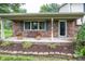 Inviting front porch with brick accents, potted flowers, and a cozy bench seating area at 2457 N Centerline Rd, Franklin, IN 46131
